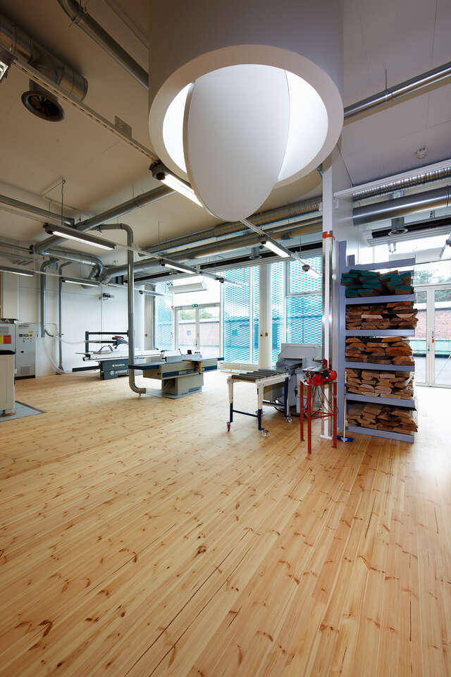 Wood workshop space with machines, materials and glazed backside
