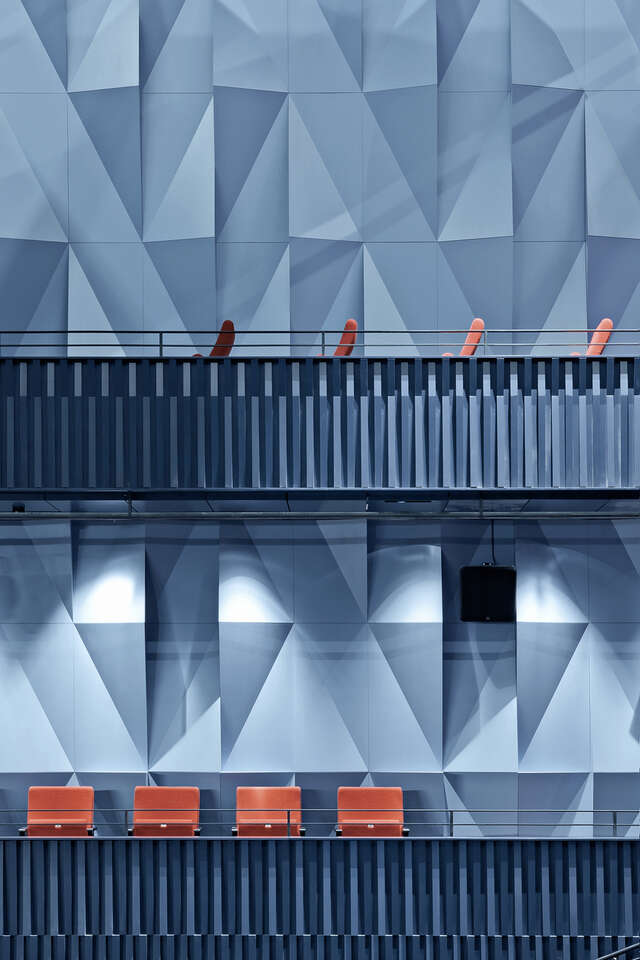 Detail of a wall with light blue panels with diagonal folds