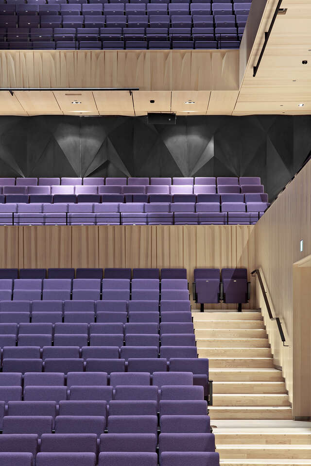 Detail on a grand hall with purple auditorium seats on three levels