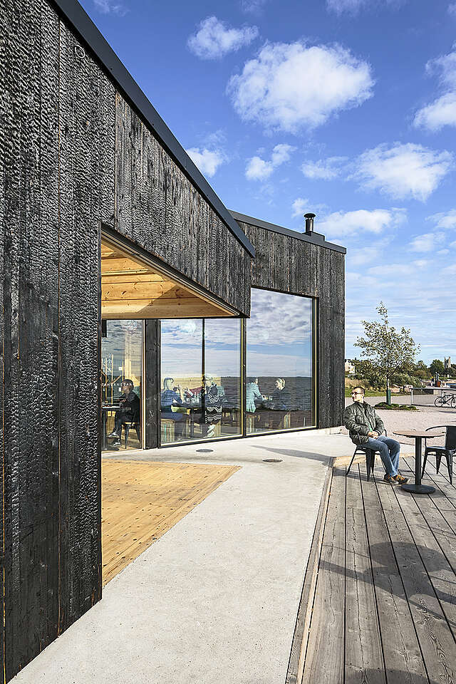 Black stained wood exterior on a sunny day.