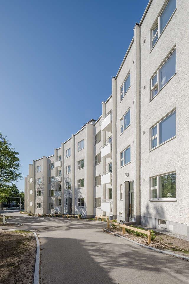 White plastered apartment building facade.