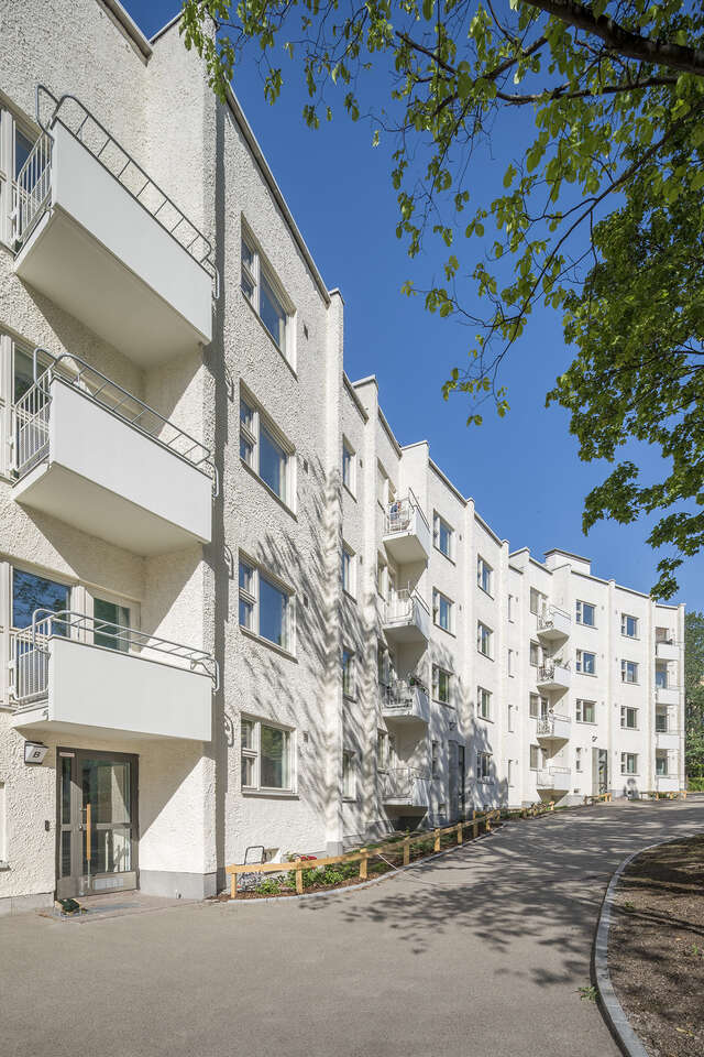 White building facade with each wall at small angle towards each other.