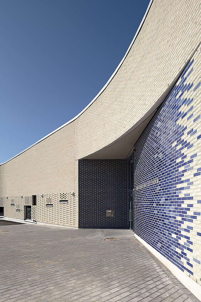 White brick facade with blue tile details.