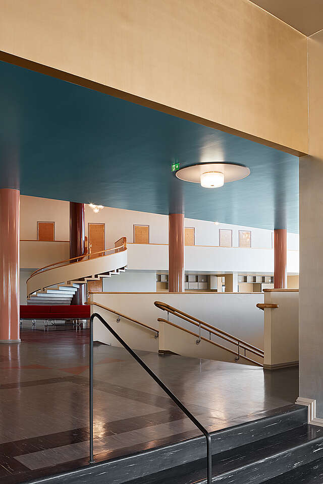 Mostly white lobby with red pink orange and blue details.
