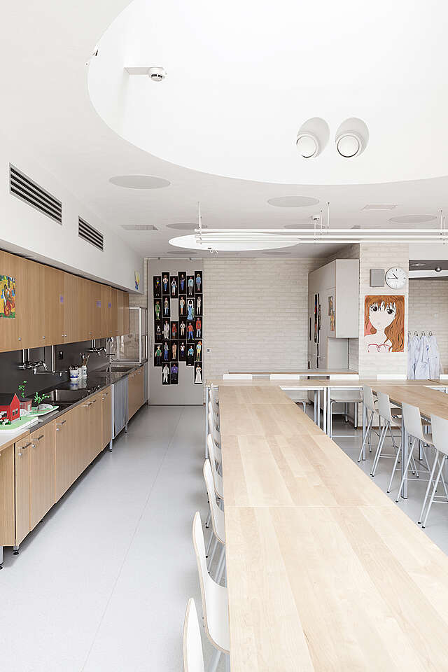 Classroom with ling desk row and the students' art on the walls.