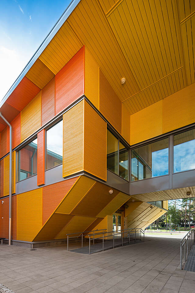 Facade with wood panels of different orange tones.
