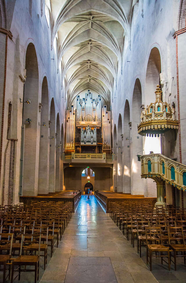 Church interior, benches behind the chairs, pulpit on the right