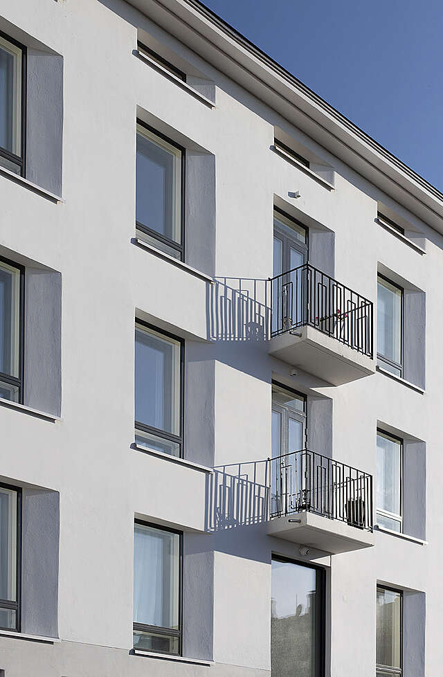 Detail of white facade, two light balconies