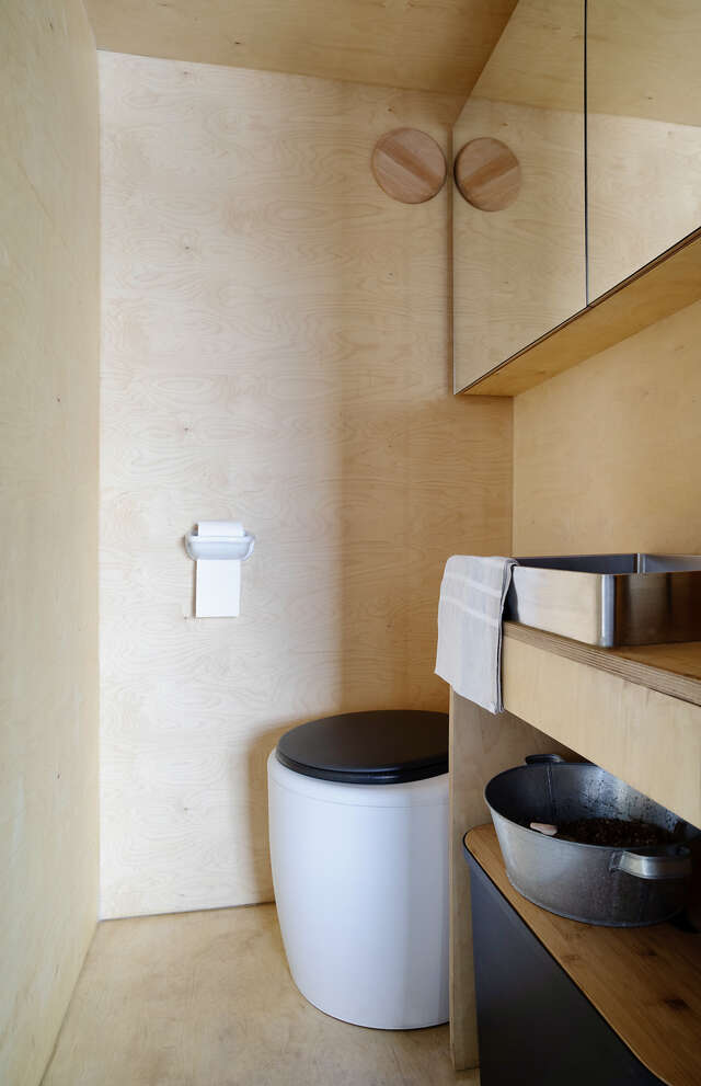 A small bathroom made of wood.